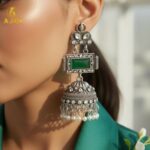 Imperial Heritage Oxidized Silver Jhumka Earrings with Deep Green Stone, Hand-Engraved Motifs, Crystal Accents & Pearl Drop Detailing. - Image 2