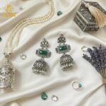 Imperial Heritage Oxidized Silver Jhumka Earrings with Deep Green Stone, Hand-Engraved Motifs, Crystal Accents & Pearl Drop Detailing. - Image 4