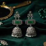 Imperial Heritage Oxidized Silver Jhumka Earrings with Deep Green Stone, Hand-Engraved Motifs, Crystal Accents & Pearl Drop Detailing. - Image 3