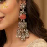 Vintage-Inspired Oxidized Silver Red Stone Jhumka Earrings with Ornate Filigree Design and Cascading Bell Danglers - Image 2