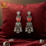Vintage-Inspired Oxidized Silver Red Stone Jhumka Earrings with Ornate Filigree Design and Cascading Bell Danglers - Image 3